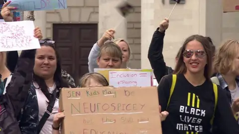 protestors holding signs