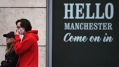 Getty Images pair walk past sign