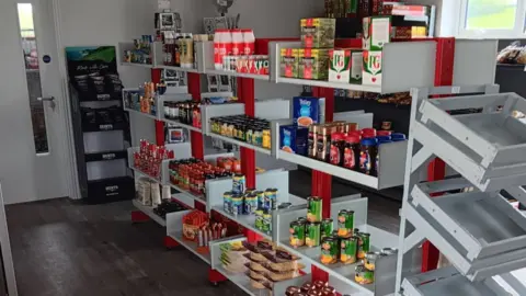 Georgina Hemmings Stacked shelves in Bridgerule's shop