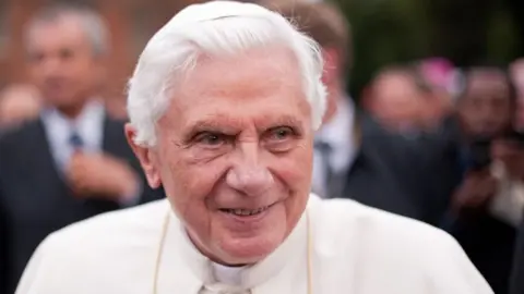 PA Media Ex pope Benedict XVI smiles in a crowd in 2020