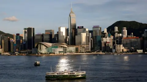 Reuters A Star Ferry boat crosses Victoria Harbour in front of a skyline of buildings in Hong Kong.