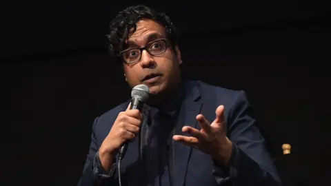 Getty Images Hari Kondabolu pictured with a microphone at screening of his documentary