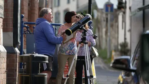 Residents in Presteigne looking into a telescope