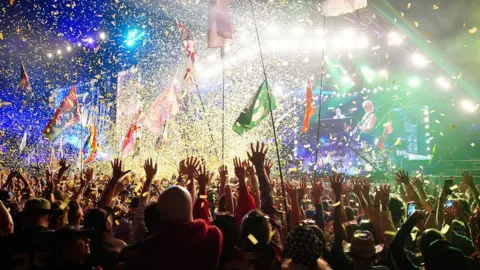 PA Media Elton John performing at Glastonbury