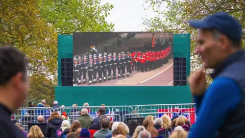 EPA-EFE/REX/Shutterstock People watching the funeral on a big screen on the Long Walk at Windsor Castle