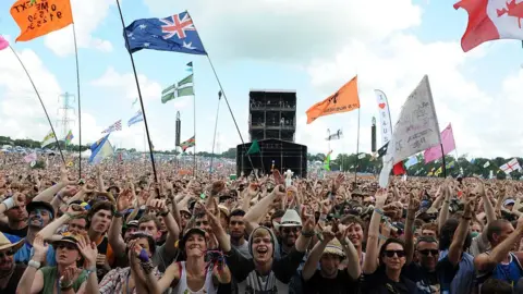 PA Media  A crowd at Glastonbury Festival