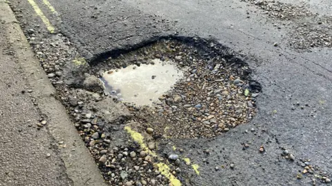 Johnnie Wright/BBC Pothole in Southwold