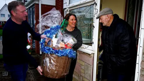 Sharon and Nigel Mather present a hamper to Tom Beevers