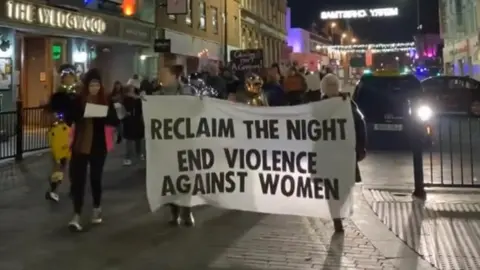 Northants Domestic Abuse Service Large banner saying "reclaim the night, end violence against women"