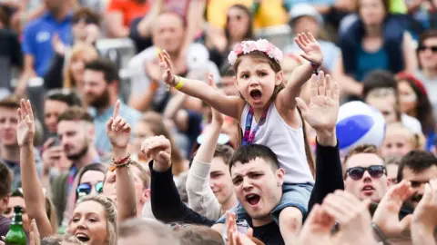 PA A young girl leads the cheers as Ed Sheeran performs during the first day of BBC Music's Biggest Weekend in Swansea