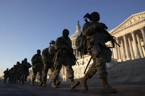 EPA Soldiers walk in a line outside the US Capitol