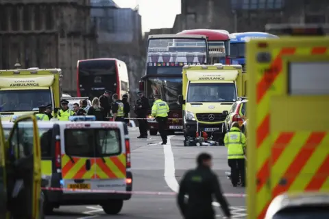 Getty Images Police and paramedics on the scene after the Westminster attack