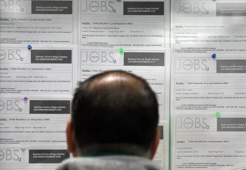 Getty Images A man looking at job adverts