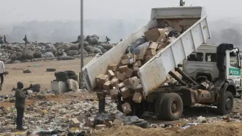 Reuters A truck offloads expired AstraZeneca coronavirus disease (COVID-19) vaccines at the Gosa dump site in Abuja, Nigeria, December 22, 2021.