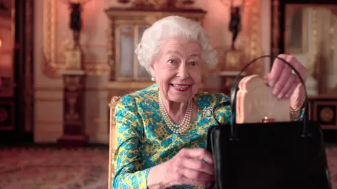 Buckingham Palace/ Studio Canal / BBC Studios The Queen reveals she has a marmalade sandwich in her bag