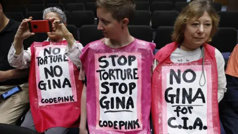 Reuters Protesters gather prior to Gina Haspel's testimony at her Senate intelligence committee confirmation on Capitol Hill in Washington, May 9, 2018