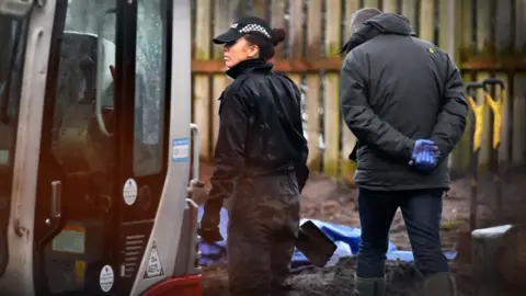 Getty Images Police searching the garden