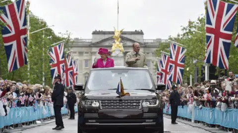 WPA Pool The Queen and Prince Philip were followed by the Duke and Duchess of Cambridge and Prince Harry as they waved to guests gathered on The Mall.