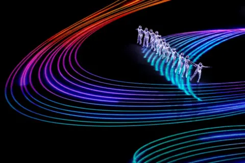 Reuters Artists perform around projected lines of coloured light