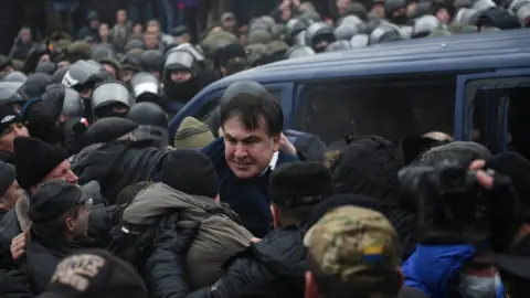 Reuters Georgian former President Mikheil Saakashvili struggles out of a police car in Kiev