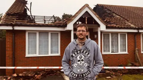 BBC Andy Harrington outside the bungalow at Queensland, Shotley