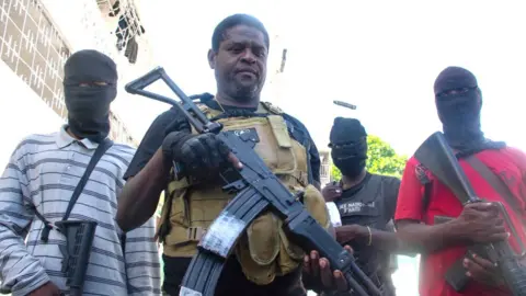 Getty Images Armed gang leader Jimmy "Barbecue" Cherizier and his men are seen in Port-au-Prince, Haiti, March 5,2024