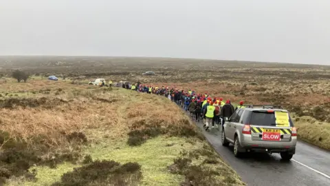 Volunteers carrying a lifeboat