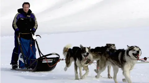 PA David Cameron driving a dog-sled on his way to the Scott-Turner glacier on the island of Svalbard, Norway in 2006
