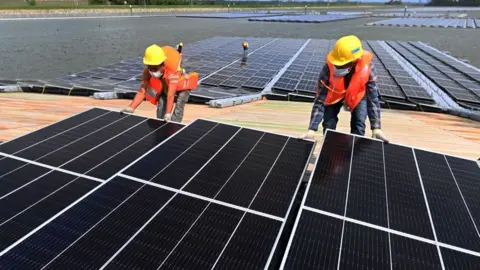 AFP workers assemble solar panels in Singapore