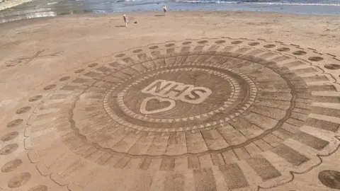 Astrality Marine Sand art for the NHS on Torquay beach