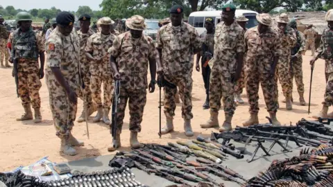 AFP Military commanders inspect arms and ammunitions recovered from Boko Haram jihadists on display at the headquarters of the 120th Battalion in Goniri, Yobe State, in Nigeria's restive northeast on July 3, 2019