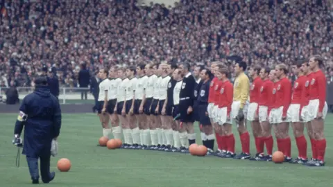 Getty Images England and Germany line up with match officials before the World Cup Final at Wembley Stadium.