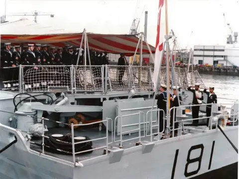Ambuscade Association Flag being lowered with soldiers on board