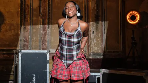 British indie pop star Rachel Chinouriri wearing tartan set designed by Annabel Stewart