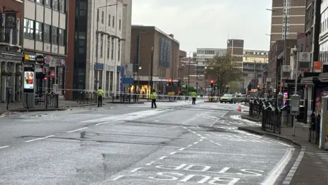 Police officers patrolling a cordon
