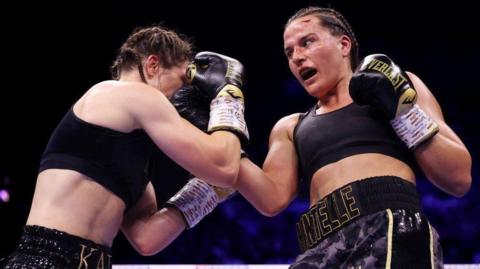 Chantelle Cameron throws a punch against Katie Taylor