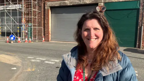 Photograph of Tameside Councillor Laura Boyle - in front of a council depot in Stalybridge.