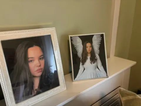 Framed photographs of a teenage girl standing on a shelf 