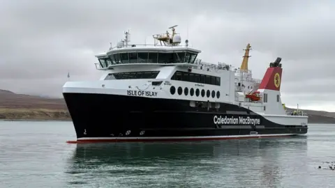 A black and white ship with red funnels and Isle of Islay written on the bow