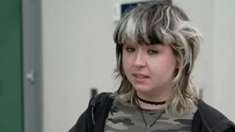 Girl with black hair and blonde highlights