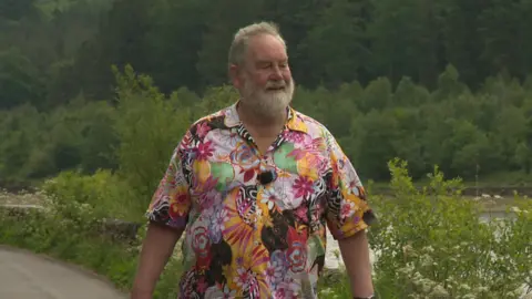 Councillor David Edwardes, the current mayor of Cheshire East Council. He is waling down a country lane.