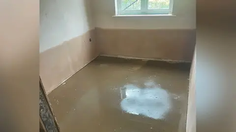 Liam Reilly A room with a window that shows water damage