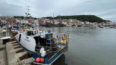 BBC/Olivia Richwald Scarborough harbour with a fishing boat in the foreground and the town in the background