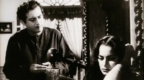 Simon & Schuster A black and white still from the film Sahib Bibi Aur Ghulam, starring Guru Dutt and Meena Kumari
