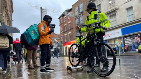 A police officer testing the speed of an e-bike in Nottingham city centre