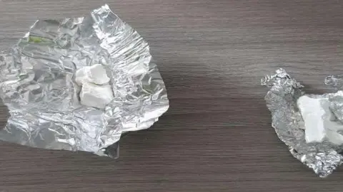 Cambridgeshire Police Cocaine is seen sitting on tin foil on top of a table.