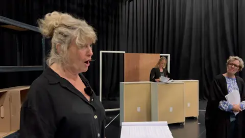 BBC Actor Liz Elvin in the witness box during play rehearsals for the drama, "Glitch'