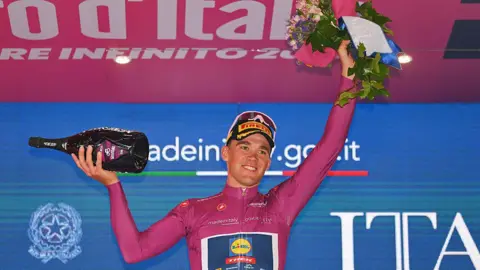Mads Pedersen celebrates on the podium at Matera