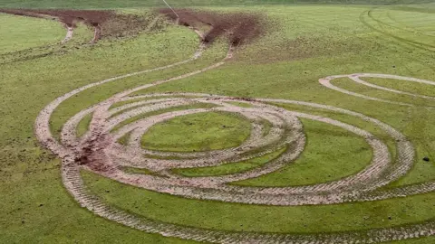 Thorndon Park Golf Club Circular tyre tracks on a golf course - about half a dozen circles have been created on a mown area of grass