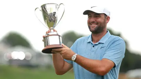 Scottie Scheffler poses with the trophy after winning the Travelers Championship in 2024